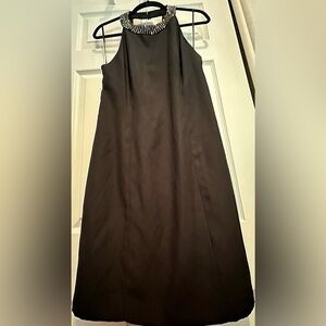 Women's little black dress with a halter neck and beaded accents.